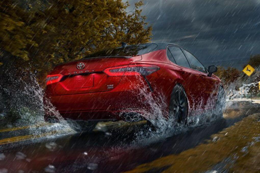2024 Red Toyota Camry Hybrid in the Rain